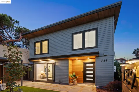 a view of a hallway with wooden floor and door