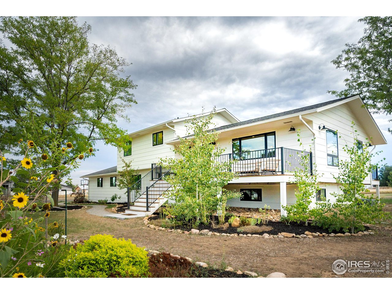 6474 Redwing Place Longmont, CO 80503 - Photo 1 of 11 a view of an apartment building and a yard