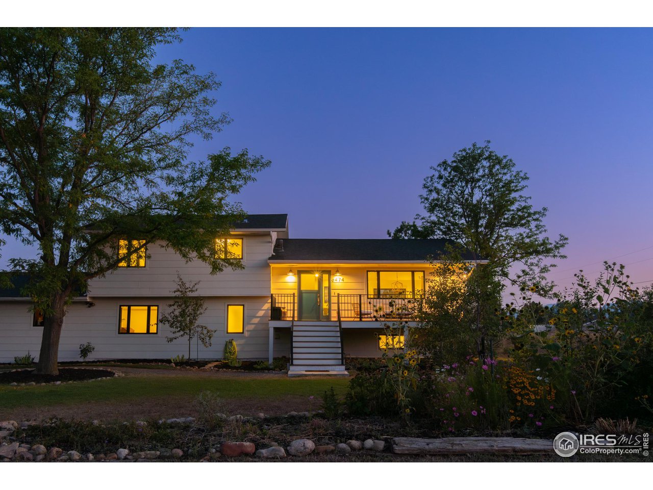 6474 Redwing Place Longmont, CO 80503 - Photo 2 of 11 a view of a big yard with a large tree front of it
