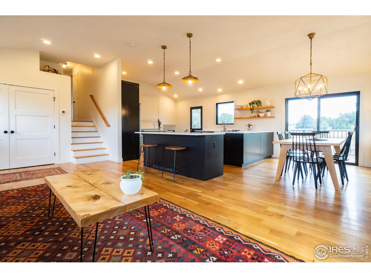 6474 Redwing Place Longmont, CO 80503 - Photo 3 of 11 a living room with dining room and wooden floor