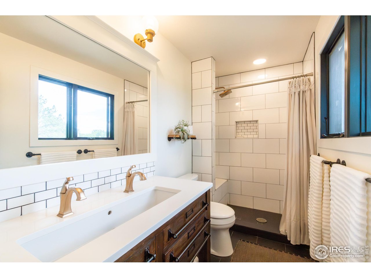 6474 Redwing Place Longmont, CO 80503 - Photo 5 of 11 a bathroom with a sink a toilet and shower