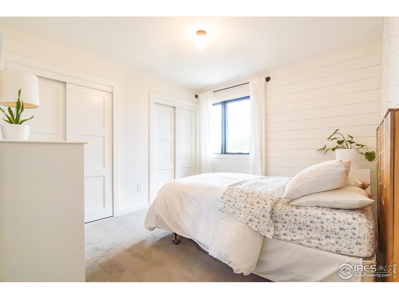 6474 Redwing Place Longmont, CO 80503 - Photo 6 of 11 a bedroom with a bed and a cabinets