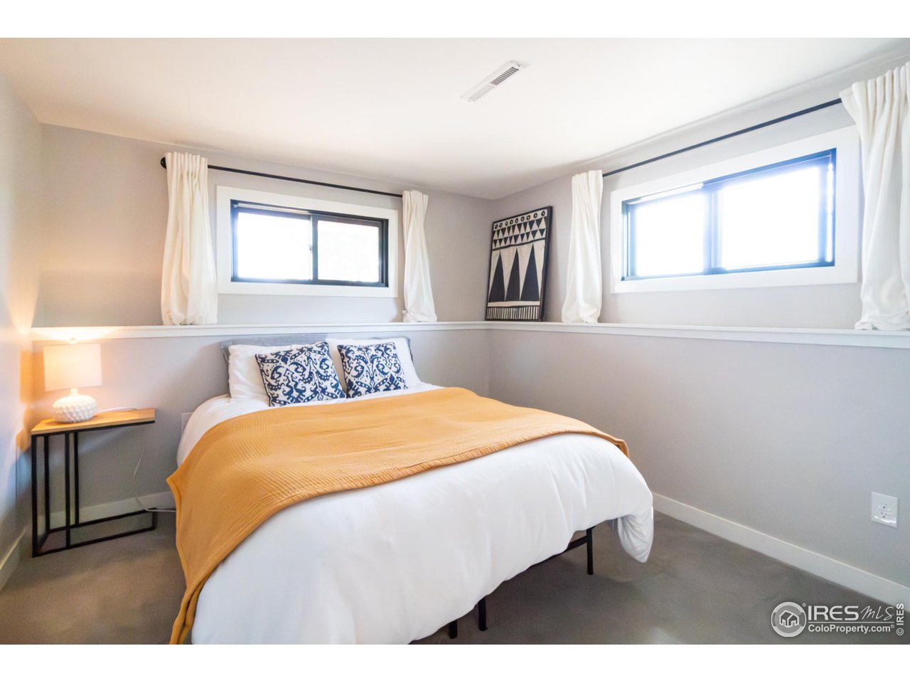 6474 Redwing Place Longmont, CO 80503 - Photo 9 of 11 a bedroom with a bed and wooden floor