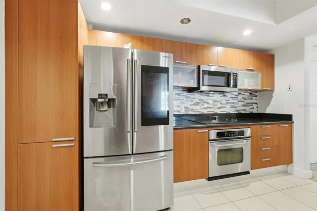 a kitchen with granite countertop a stove and a sink