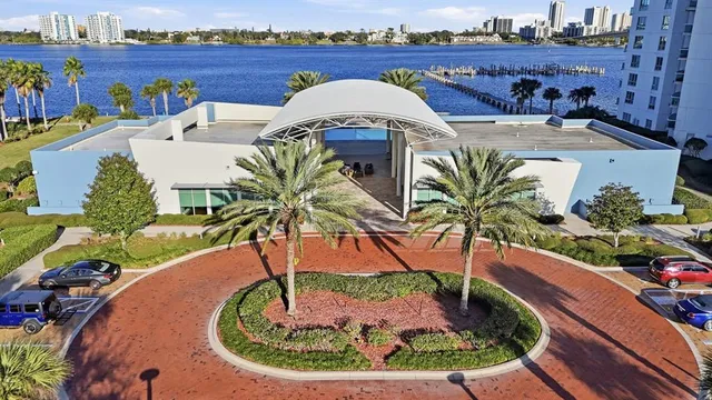 a living room with fireplace furniture and a potted plant