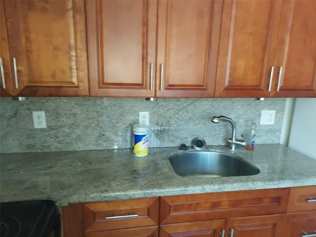 a kitchen with sink and cabinets