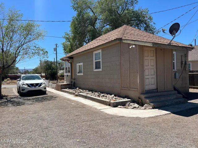 a backyard of a house with yard and outdoor seating