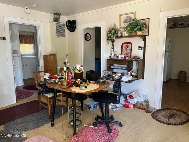 a view of a dining room with furniture and rug