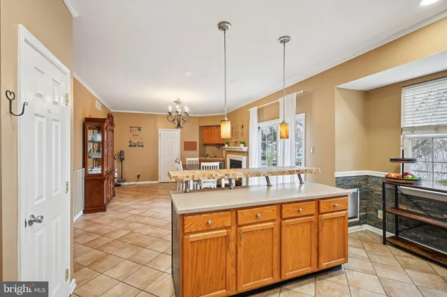 a dining hall with stainless steel appliances granite countertop a sink and cabinets