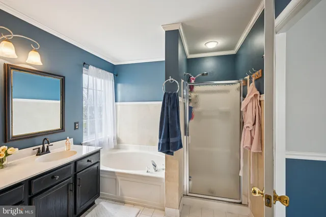 a bathroom with a tub sink and mirror