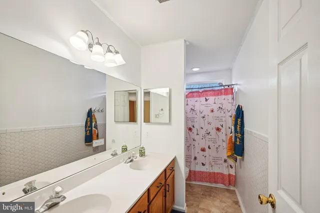 a bathroom with a sink a mirror and a shower