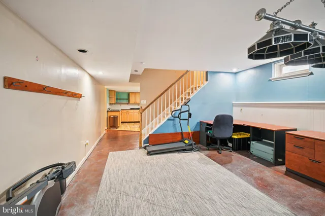 a room with lots of white furniture and wooden floors