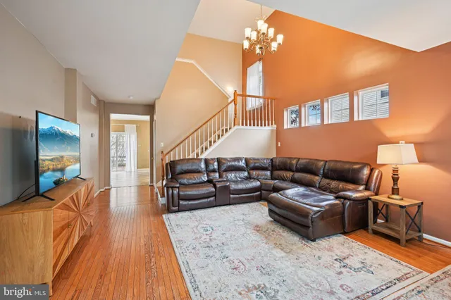 a living room with furniture and a chandelier