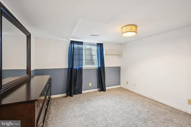 a room with a dresser and a mirror