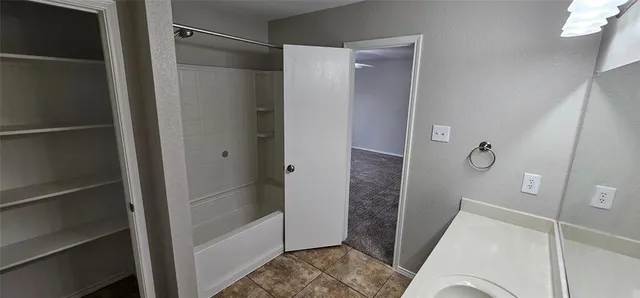 a bathroom with a shower and a sink