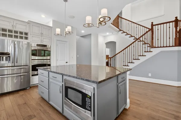 a kitchen with granite countertop a sink and stainless steel appliances