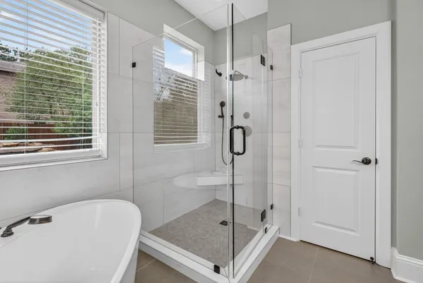 a bathroom with a bath tub and a shower