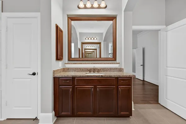 a view of a door wooden cabinets and a hallway