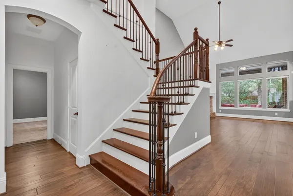 a view of entryway and hall with wooden floor