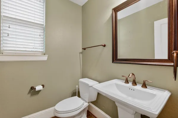 a bathroom with a sink a mirror and a toilet