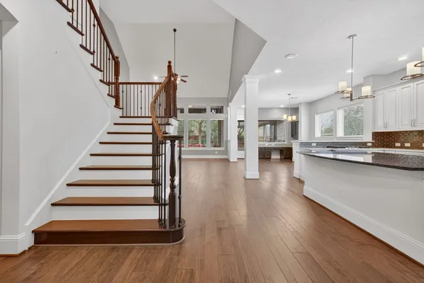a view of kitchen with sink and wooden floor