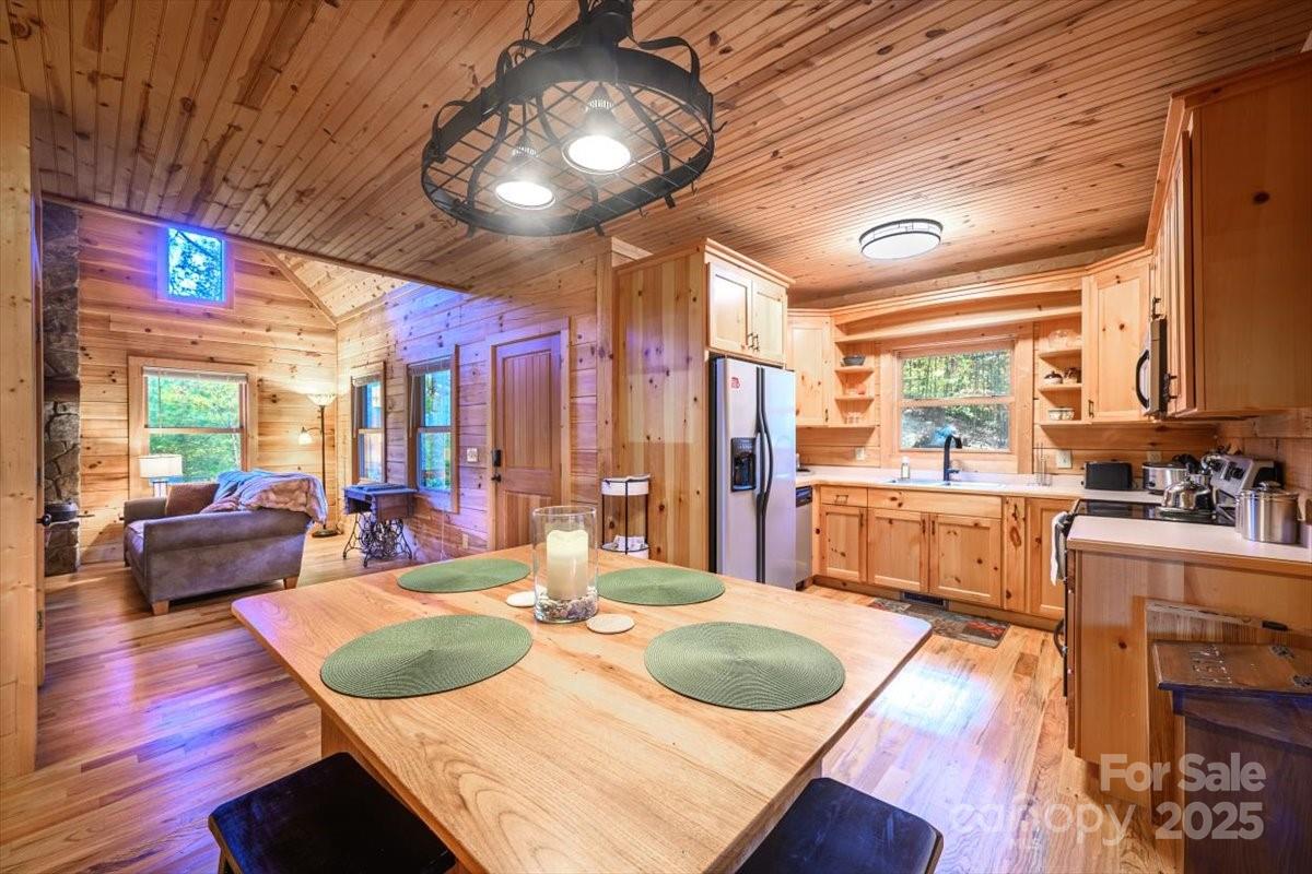 87 Prater Cove Road Franklin, NC 28734 - Photo 23 of 34 a view of a dining room with furniture a chandelier and wooden floor