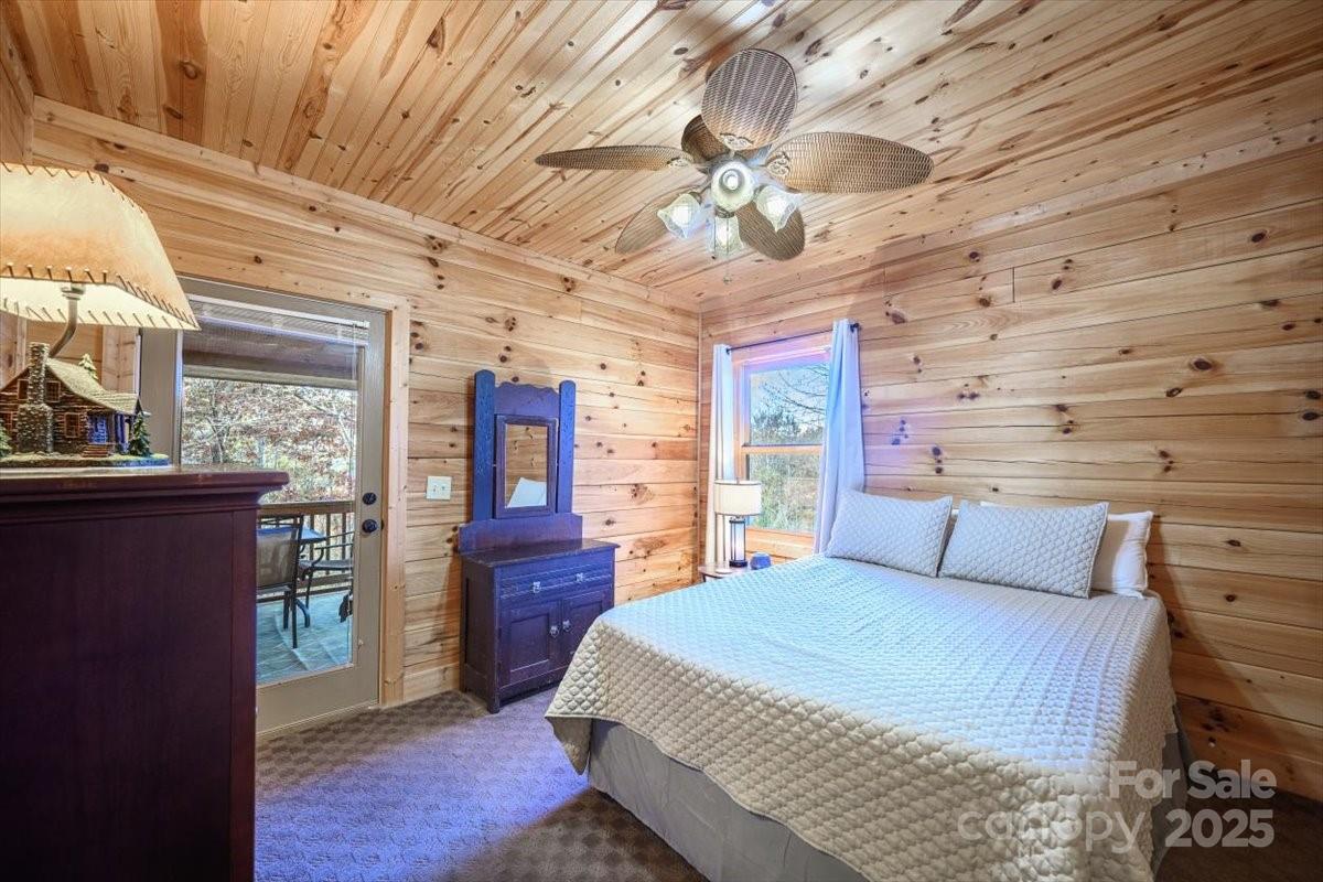 87 Prater Cove Road Franklin, NC 28734 - Photo 25 of 34 a bedroom with a large bed and a large window