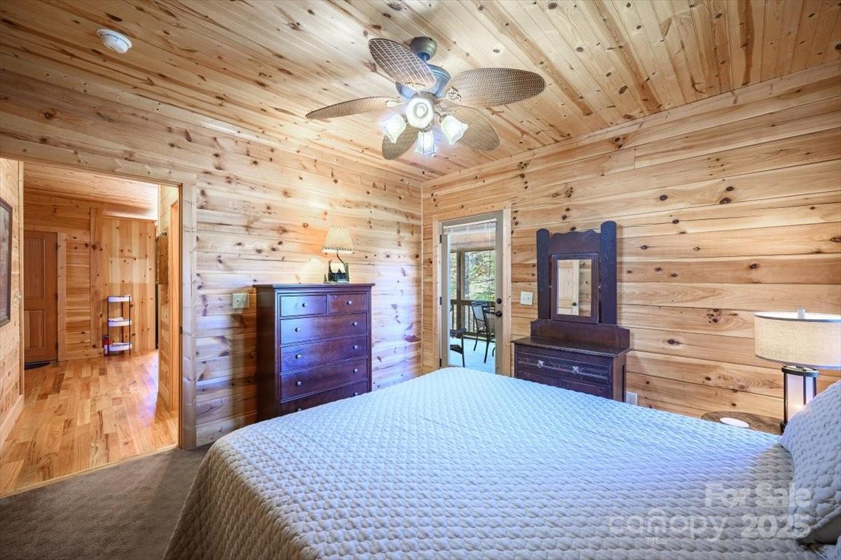 87 Prater Cove Road Franklin, NC 28734 - Photo 26 of 34 a bedroom with a bed and wooden floor