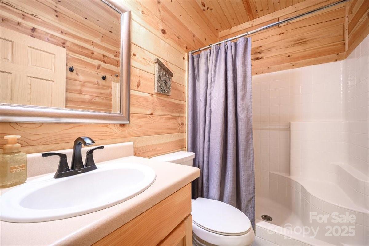 87 Prater Cove Road Franklin, NC 28734 - Photo 27 of 34 a bathroom with a sink toilet and shower