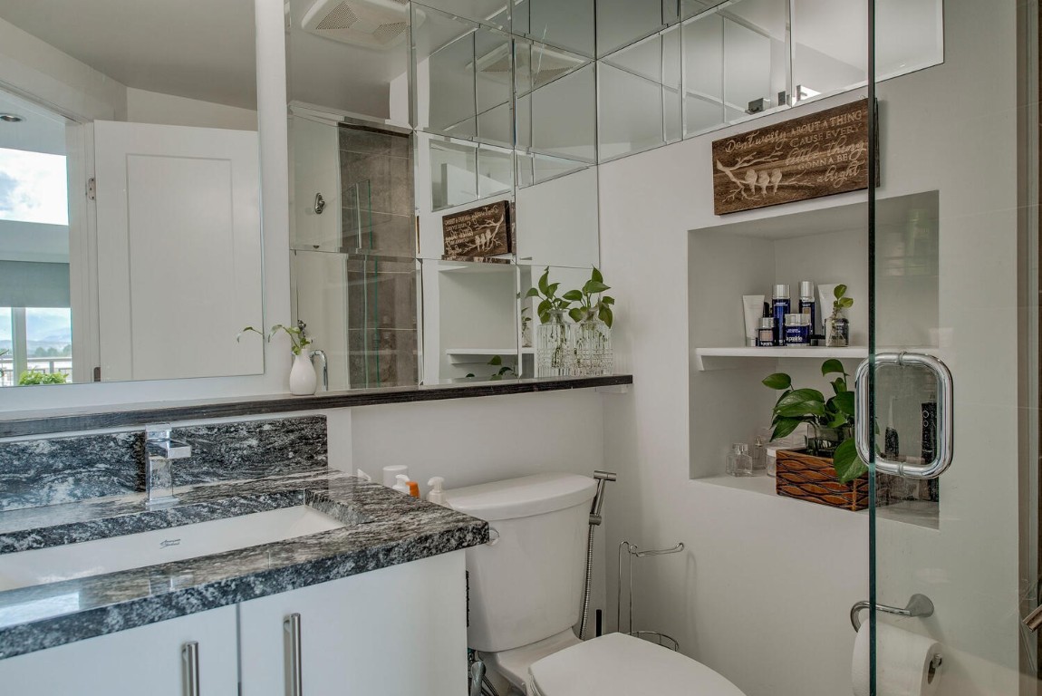 100 Basecamp Way, Unit 217 Frisco, CO 80443 - Photo 12 of 39 a bathroom with a granite countertop sink a toilet and mirror