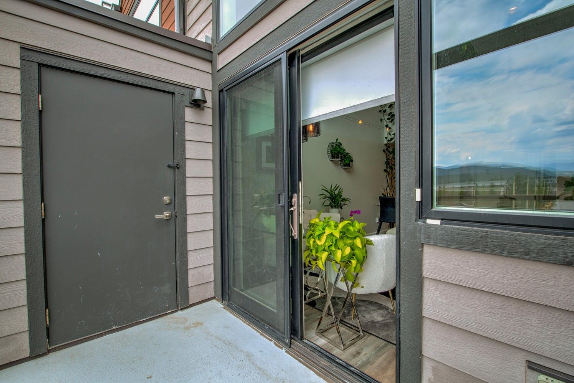 100 Basecamp Way, Unit 217 Frisco, CO 80443 - Photo 17 of 39 a glass door with a bench and dining table