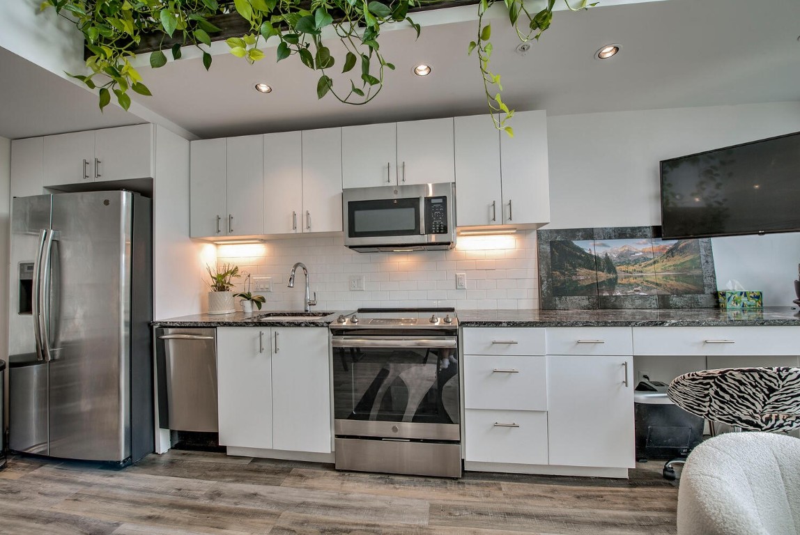 100 Basecamp Way, Unit 217 Frisco, CO 80443 - Photo 6 of 39 a kitchen with stainless steel appliances granite countertop a refrigerator stove and sink