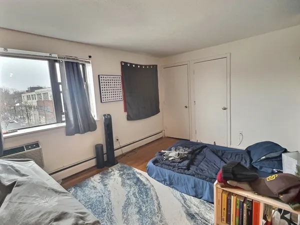 a bedroom with furniture and a window