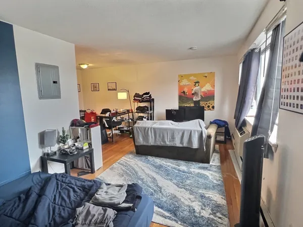 a bedroom with furniture and a flat screen tv