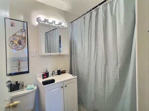 a kitchen with a sink a stove top oven and cabinetry