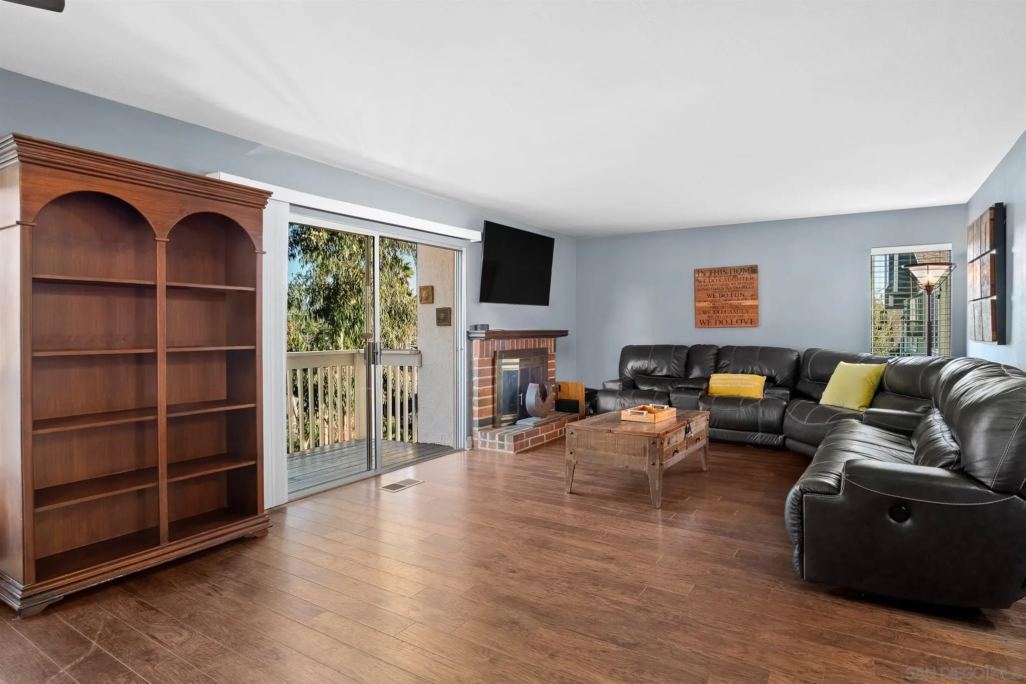 330 Rock Ridge Place Escondido, CA 92027 - Photo 12 of 32 a living room with furniture a flat screen tv and a fireplace