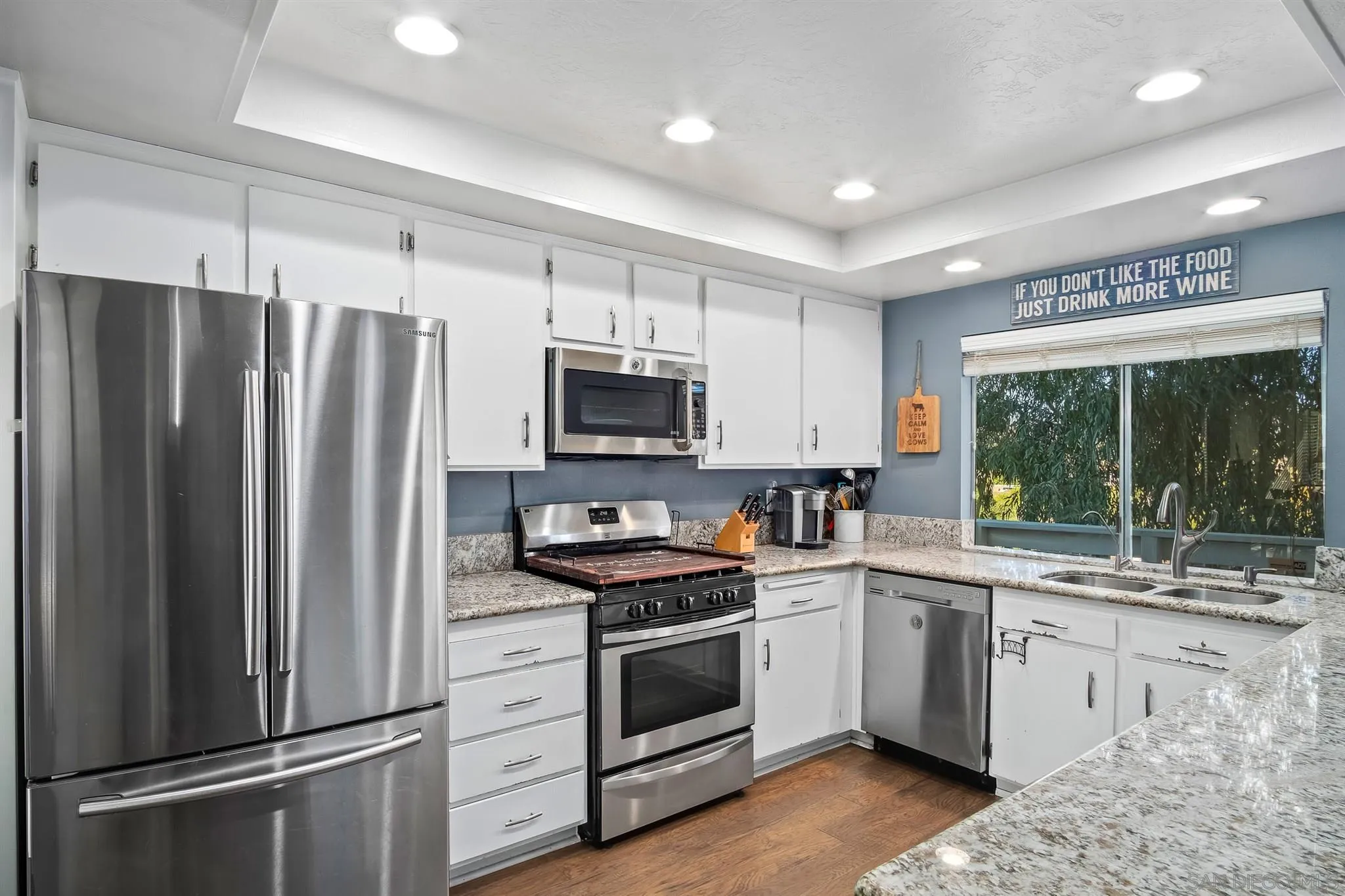 330 Rock Ridge Place Escondido, CA 92027 - Photo 8 of 32 a kitchen with stainless steel appliances a refrigerator sink and cabinets