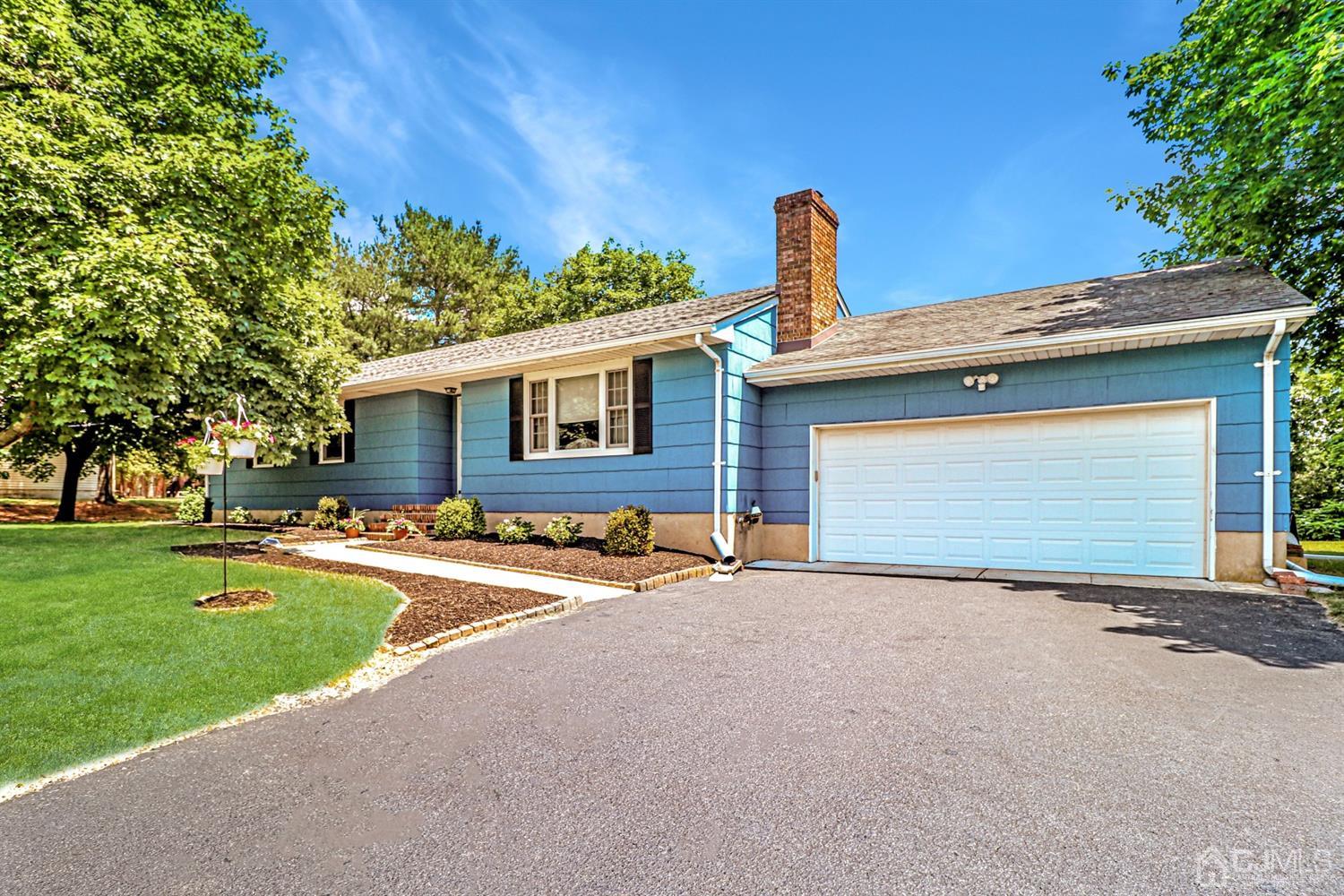 434 Hoffman Station Road Monroe Township, NJ 08831 - Photo 2 of 36 a front view of a house with a yard and garage