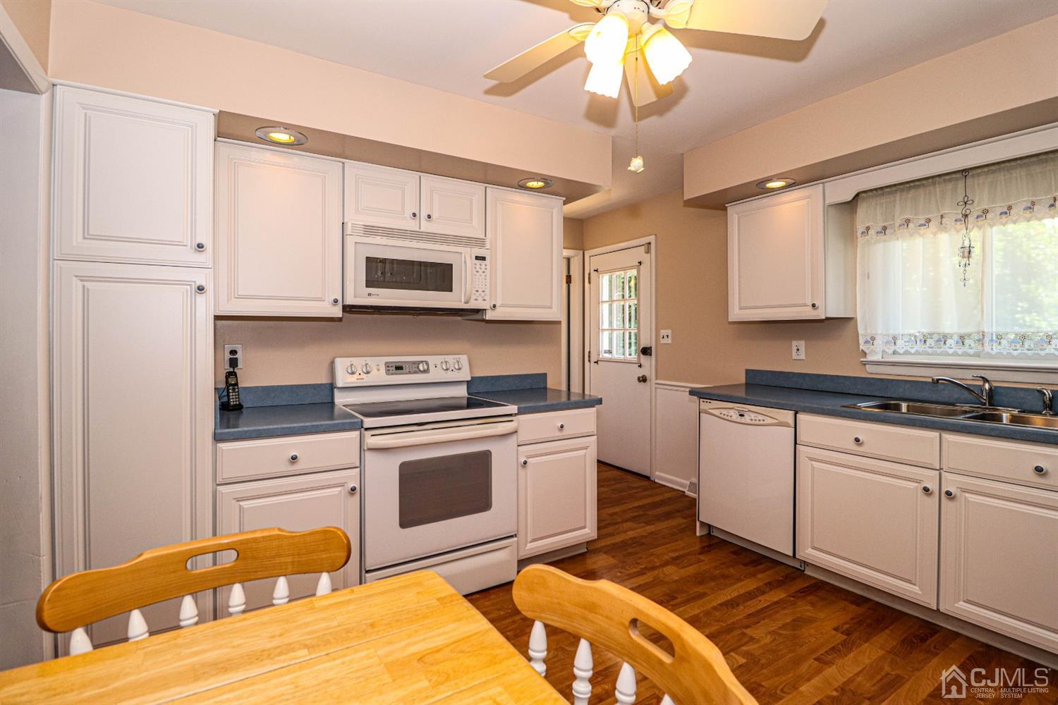 434 Hoffman Station Road Monroe Township, NJ 08831 - Photo 12 of 36 a kitchen with stainless steel appliances granite countertop a stove a sink and a microwave