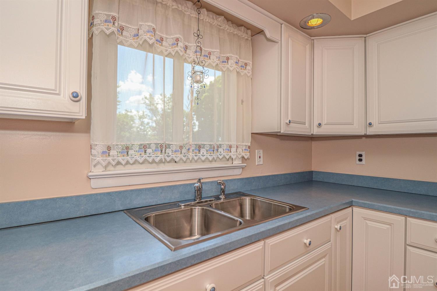 434 Hoffman Station Road Monroe Township, NJ 08831 - Photo 15 of 36 a kitchen with a sink cabinets and window