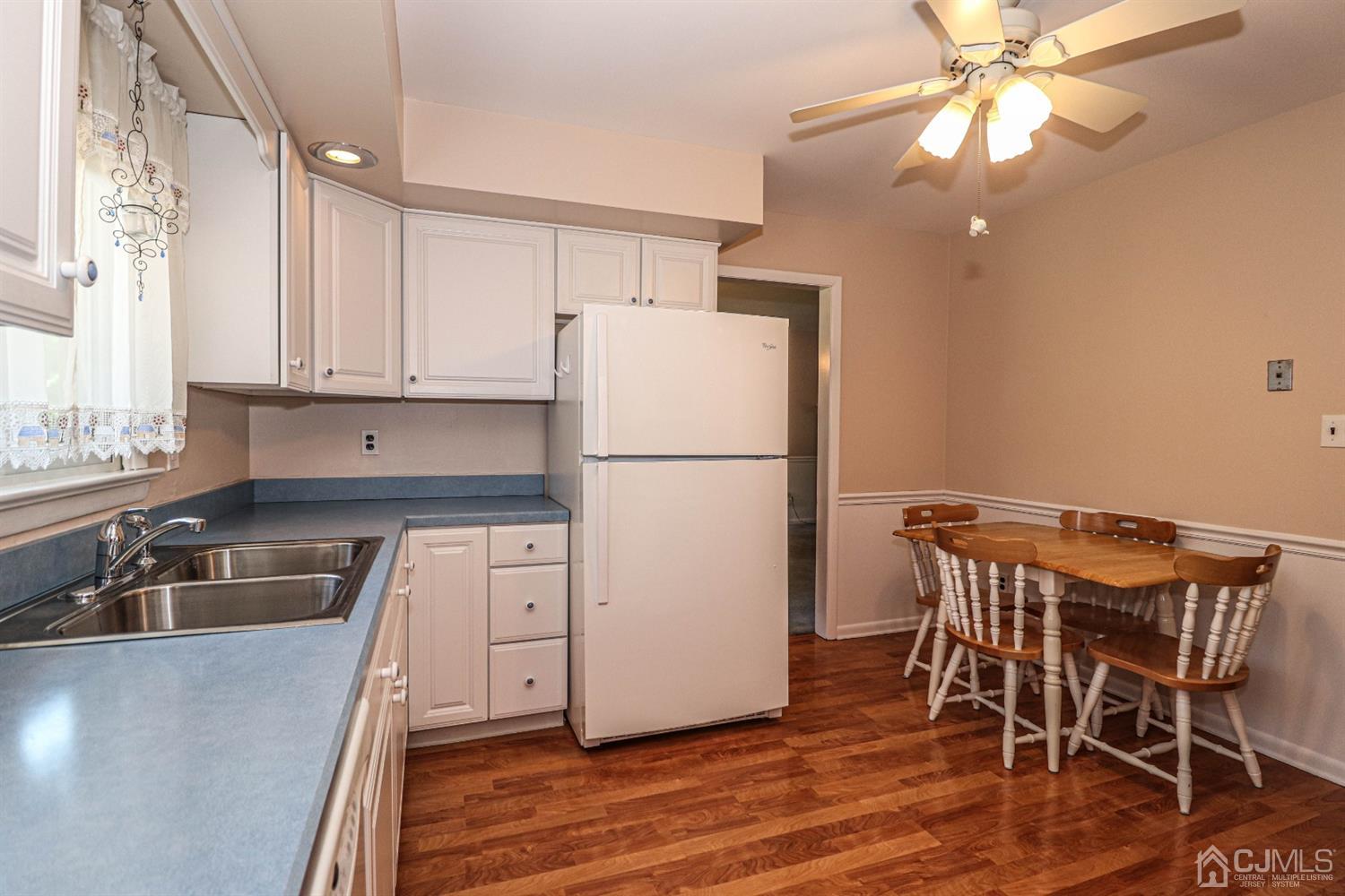 434 Hoffman Station Road Monroe Township, NJ 08831 - Photo 16 of 36 a kitchen with stainless steel appliances granite countertop a refrigerator sink and white cabinets