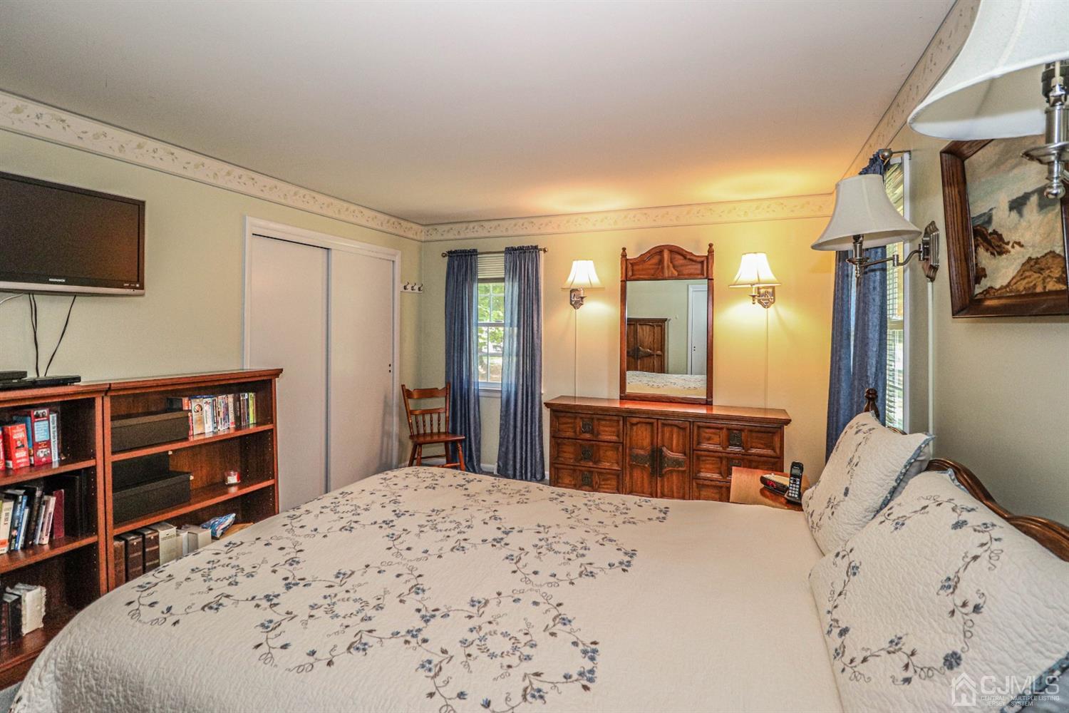 434 Hoffman Station Road Monroe Township, NJ 08831 - Photo 18 of 36 a bedroom with a bed and a flat screen tv