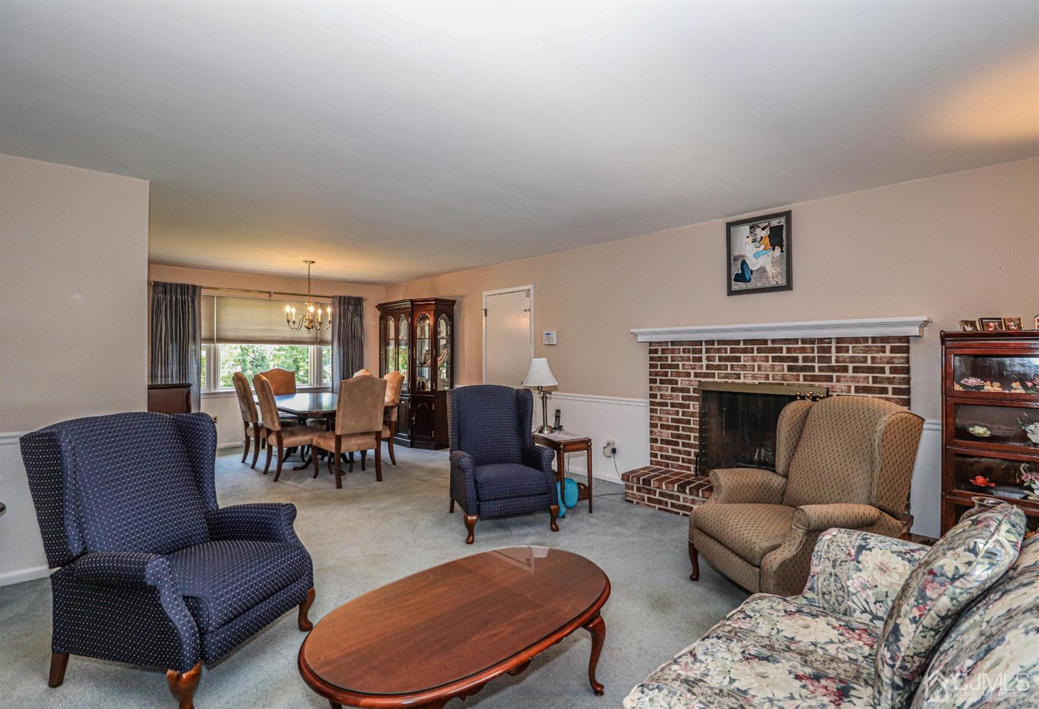 434 Hoffman Station Road Monroe Township, NJ 08831 - Photo 8 of 36 a living room with furniture a rug and a fireplace