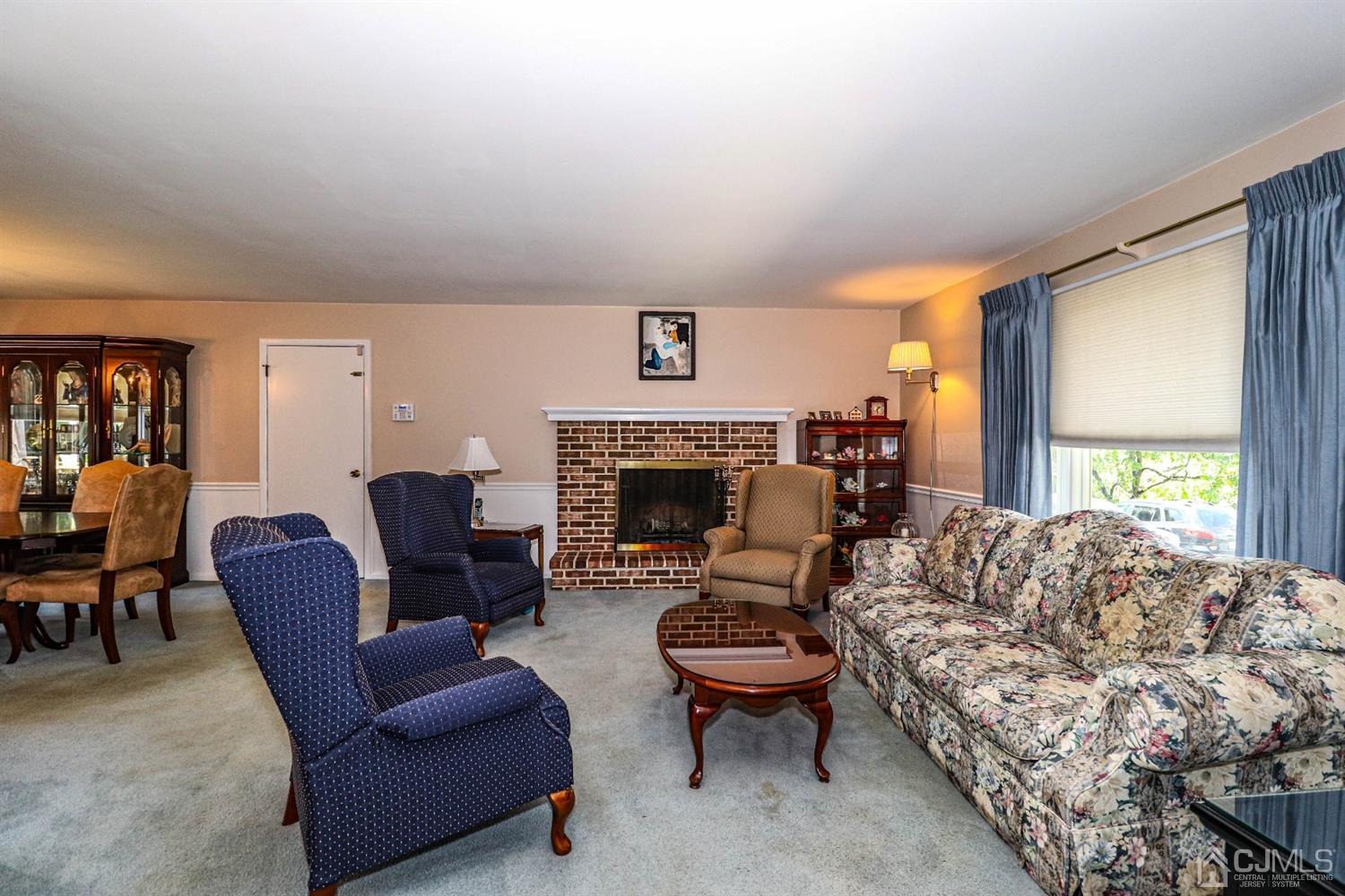 434 Hoffman Station Road Monroe Township, NJ 08831 - Photo 9 of 36 a living room with furniture a fireplace and a large window