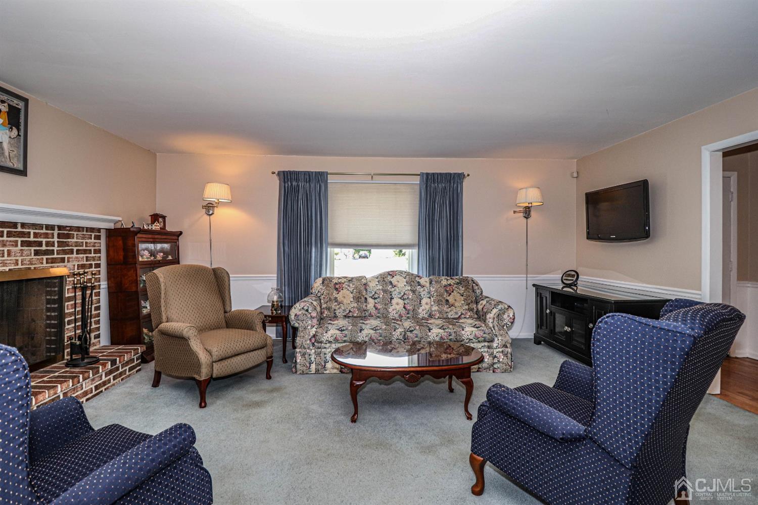 434 Hoffman Station Road Monroe Township, NJ 08831 - Photo 10 of 36 a living room with furniture and a flat screen tv