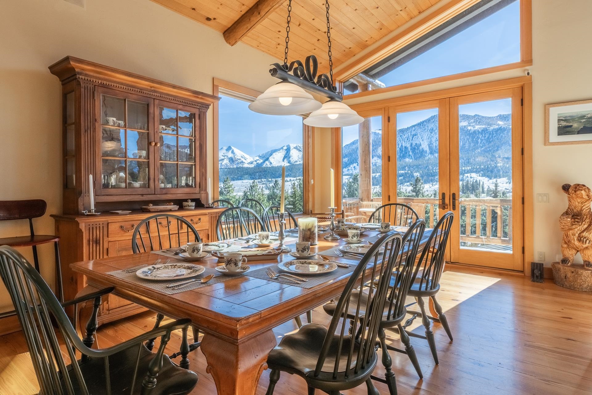 91 Ridge Way Mammoth Lakes, CA 93546 - Photo 11 of 49 a view of a dining room with furniture large windows and wooden floor
