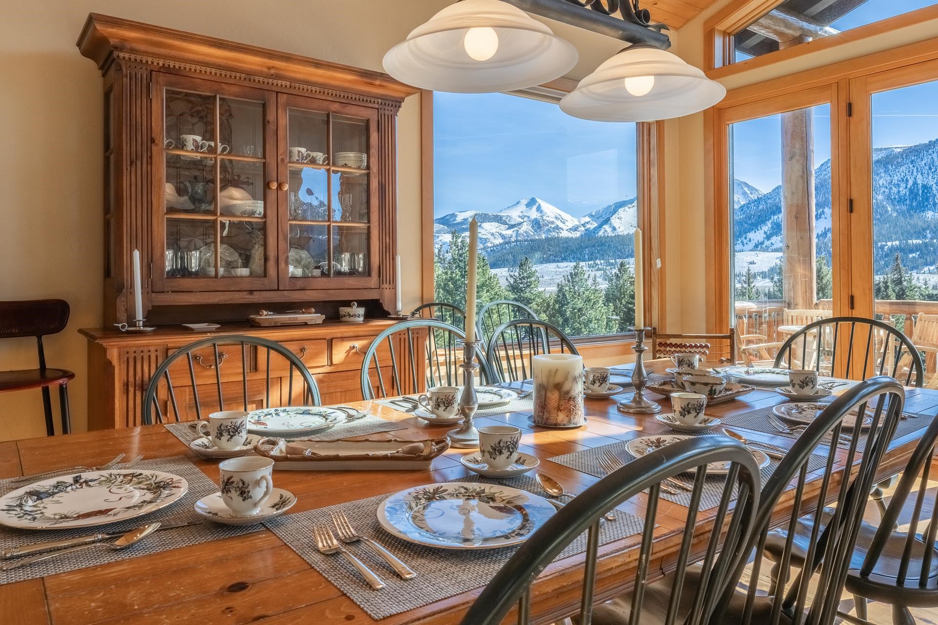 91 Ridge Way Mammoth Lakes, CA 93546 - Photo 12 of 49 a view of a dining room with furniture large windows and wooden floor