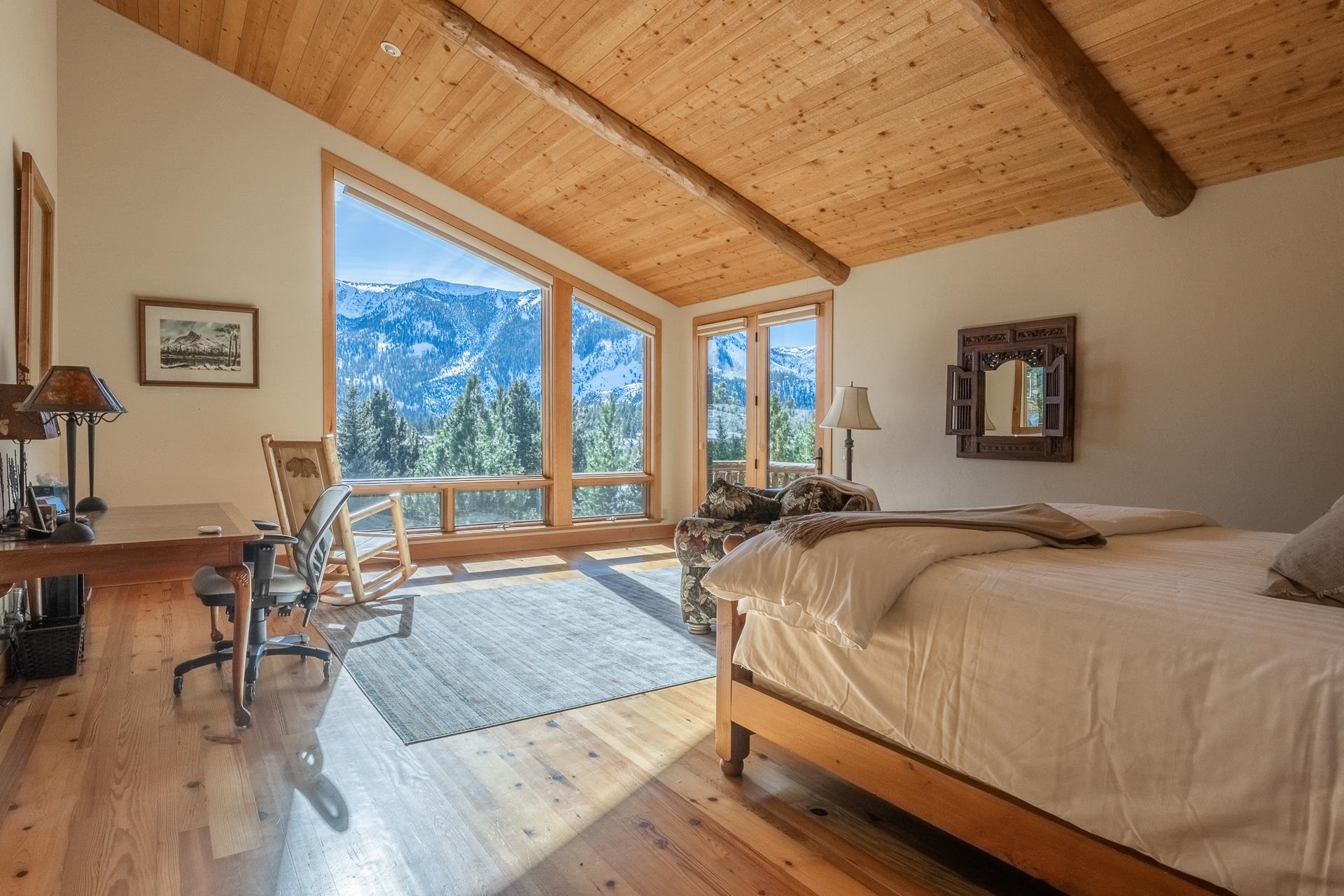 91 Ridge Way Mammoth Lakes, CA 93546 - Photo 18 of 49 a bedroom with a bed a table and chair with wooden floor