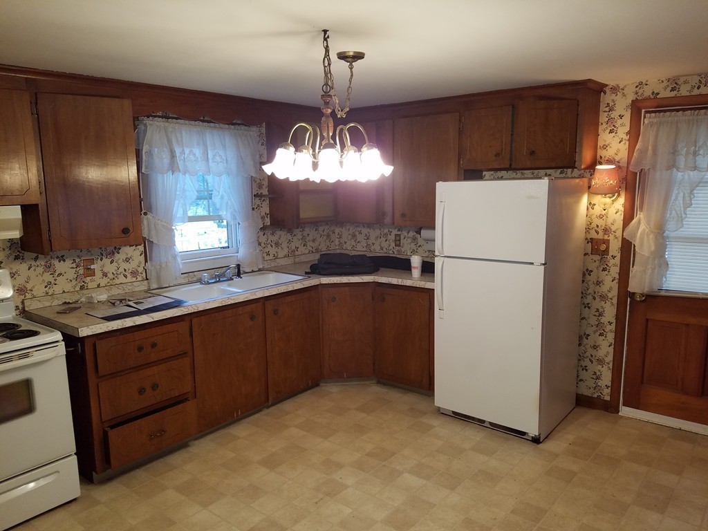 20 Lackey Dam Road Sutton, MA 01590 - Photo 4 of 20 a kitchen with cabinets a refrigerator and a sink