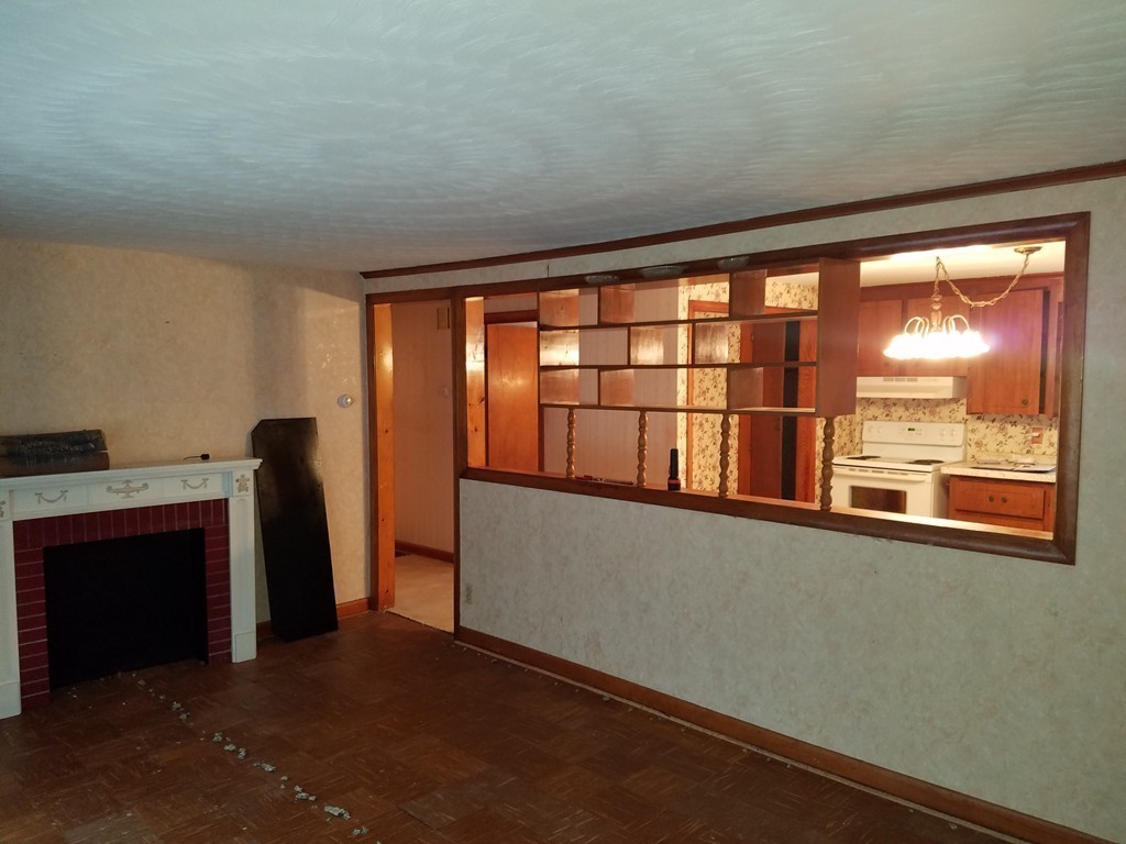 20 Lackey Dam Road Sutton, MA 01590 - Photo 8 of 20 a view of an empty room with a fireplace and a window